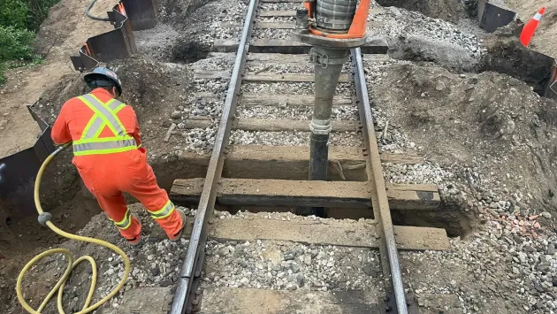 Clearing work between closely spaced railway sleepers.